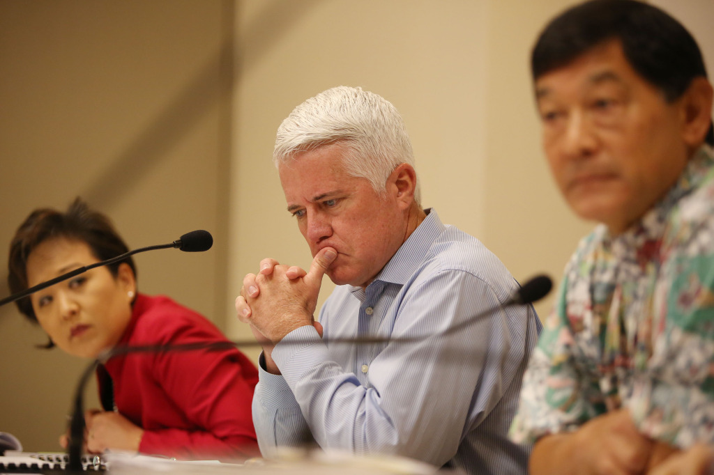 Center, HART Boardmember Michael Formby at HART board meeting held at Kapolei Hale flanked left, HART boardmember Carrie Okinaga and right, HART Board Chair Ivan Lui-Kwan. 18 dec 2014. photo Cory Lum.