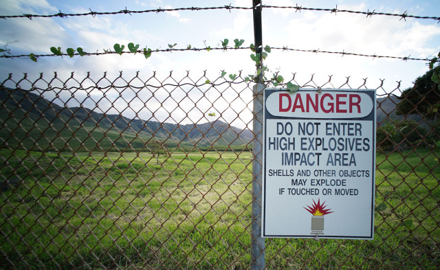 Sign and barbed wired fence fronting Makua Valley. 14 march 2015. photograph Cory Lum/Civil Beat