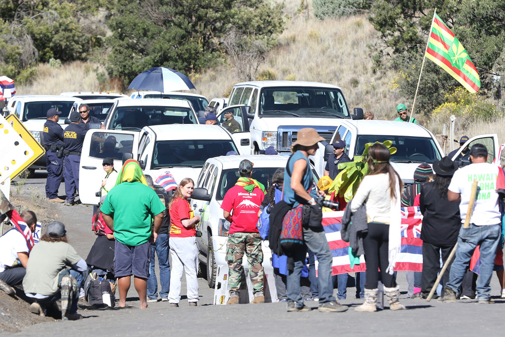 DLNR vehicles are stopped at the bottom of the road leading to the summit of Mauna Kea early in the morning.  The demonstrators strategized by having many layers of supporters, creating a barrier against TMT workers trying to reach the summit.  24 june 2015. photograph Cory Lum/Civil Beat