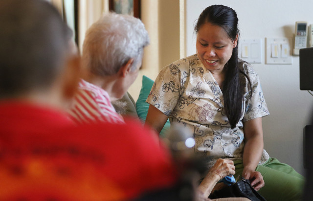 CNA Juvy Requilman talks to residents at Hokulaki Senior Living care home in Kaneohe. 14 aug 2015. photograph Cory Lum/Civil Beat