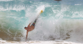 Bodysurfer enjoys being airborne (hope his arm/body ok)  on large surf generated by approacing swell from tropical storm Guillermo as the storm skirts along the Hawaiian islands. photograph Cory Lum/Civil Beat