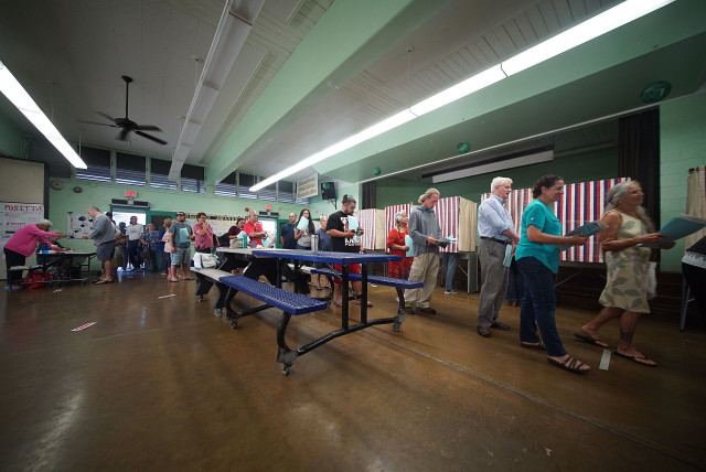 Scores stand in line to have paper ballots scanned after voting at Hauula Elementary. The line to turn ballot in was longer than ballot pickup due to the 2nd page of ballot. 8 nov 2016
