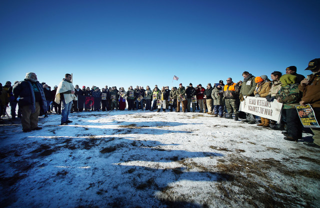 Scores of verterans and media gather by Standing Rock supporters with Congresswoman Tulsi Gabbard near Cannonball field, near the Standing Rock camp site. 4 dec 2016