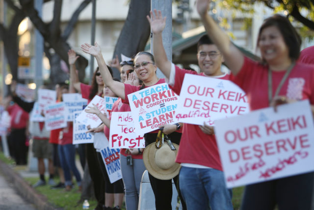 McKinley High School faculty/teachers hold signs along King Street. 7 march 2017