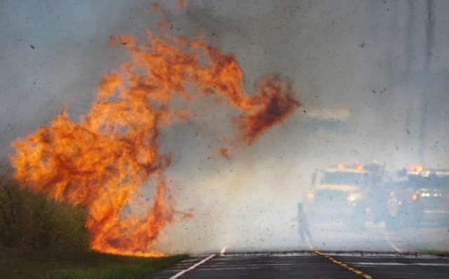 Honolulu Fire Department firefighters battle brush fire along Kunia Road today.