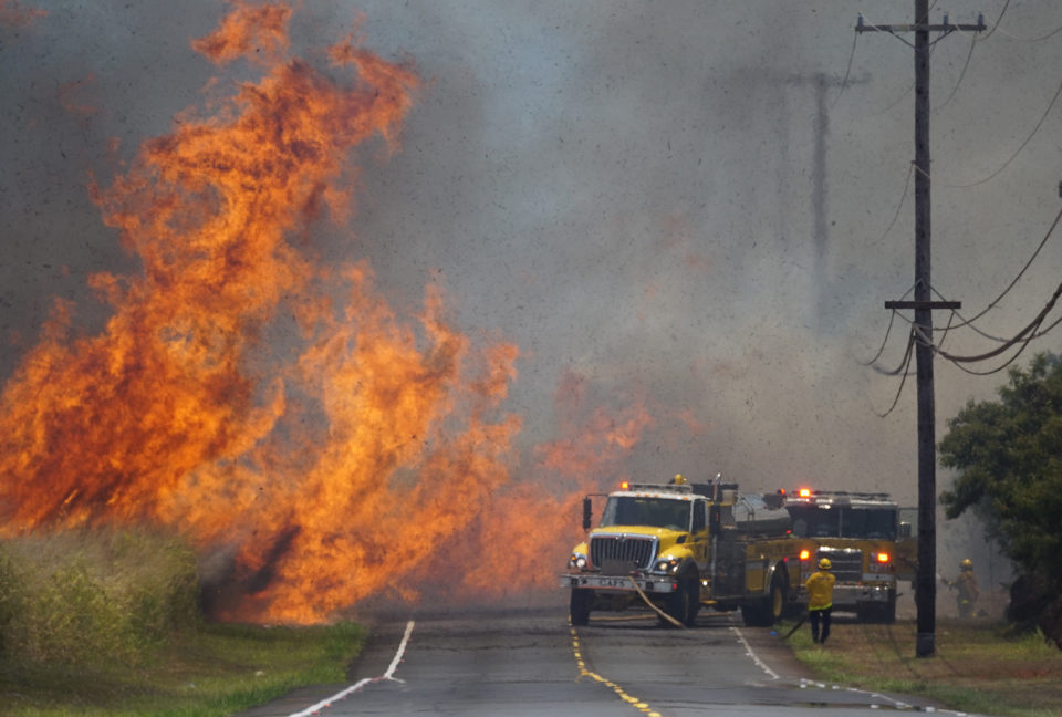 Honolulu Fire Department firefighters battle brush fire along Kunia Road.