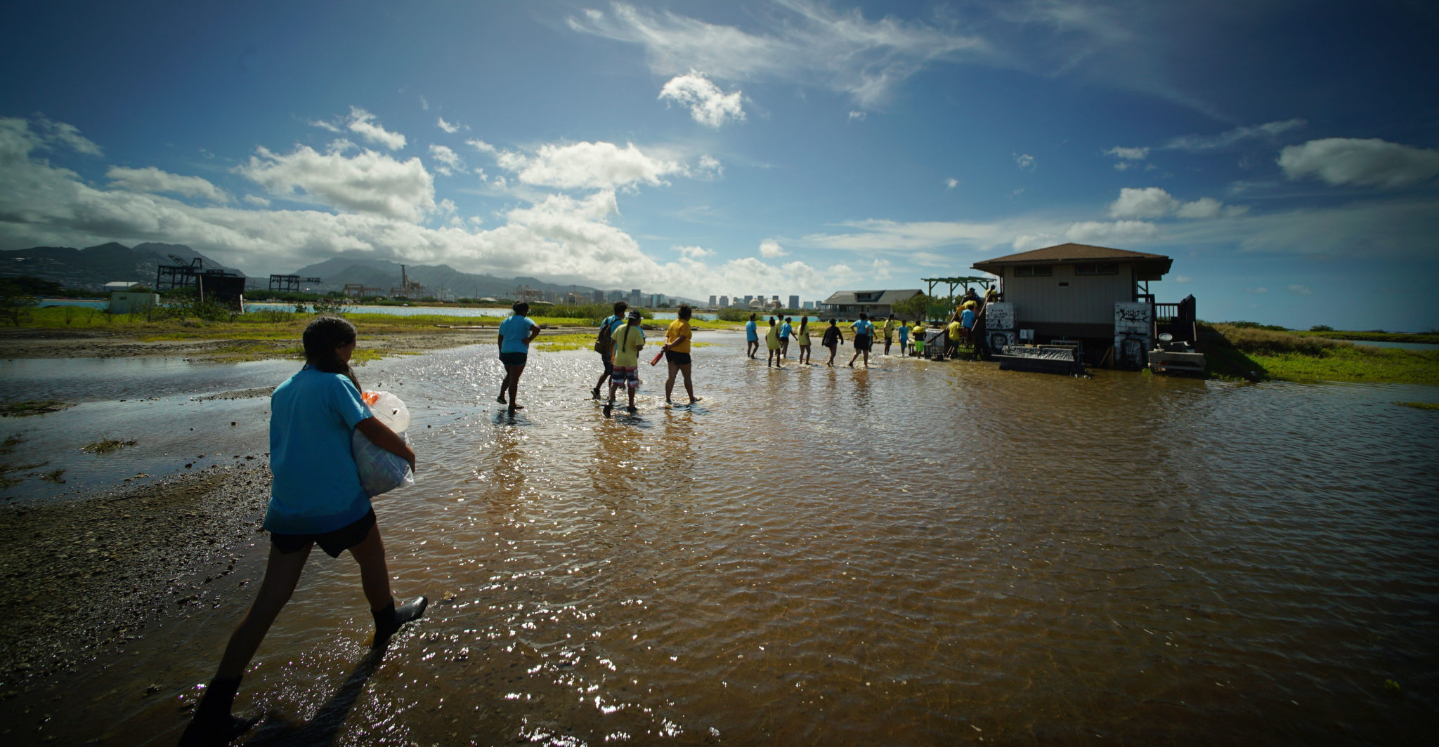 Mokauea Island students cross king tide flooded area