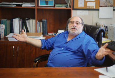 Federal Public Defender Alexander Silvert gestures towards reporter during interview in his office located at the Federal Building.