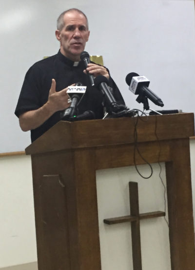 Archbishop Michael J. Byrnes announces that the Roman Catholic Church in Guam will file Chapter 11 reorganization bankruptcy in the coming weeks, Wednesday, Nov. 7, 2018, in Hagatna, Guam. The move will allow the archdiocese to avoid trial in dozens of lawsuits alleging child sexual abuse by priests and move toward settlements. (AP Photo/Grace Garces Bordallo)