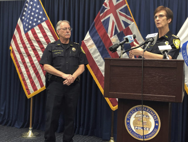 Honolulu Police Deputy Chief John McCarthy, left, listens as Honolulu Police Chief Susan Ballard, right, speaks at a news conference on Tuesday, Jan. 29, 2019, in Honolulu about a crash that killed three pedestrians. (AP Photo/Jennifer Sinco Kelleher)