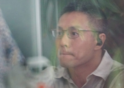 Bobby Nguyen waits outside District Court.