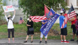 Trump supporters gather near the Capitol along King Street holding flags and signs.