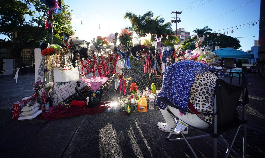 People sleep along Kalakaua Avenue and Philip Street where a memorial was erected to honor Iremamber Sykap after being shot by the Honolulu Police Department. Photo taken on April 14, 2021