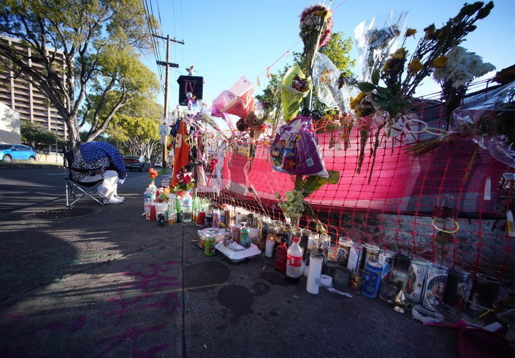 People sleep along Kalakaua Avenue and Philip Street where a memorial was erected to honor Iremamber Sykap after being shot by the Honolulu Police Department. Photo taken on April 14, 2021
