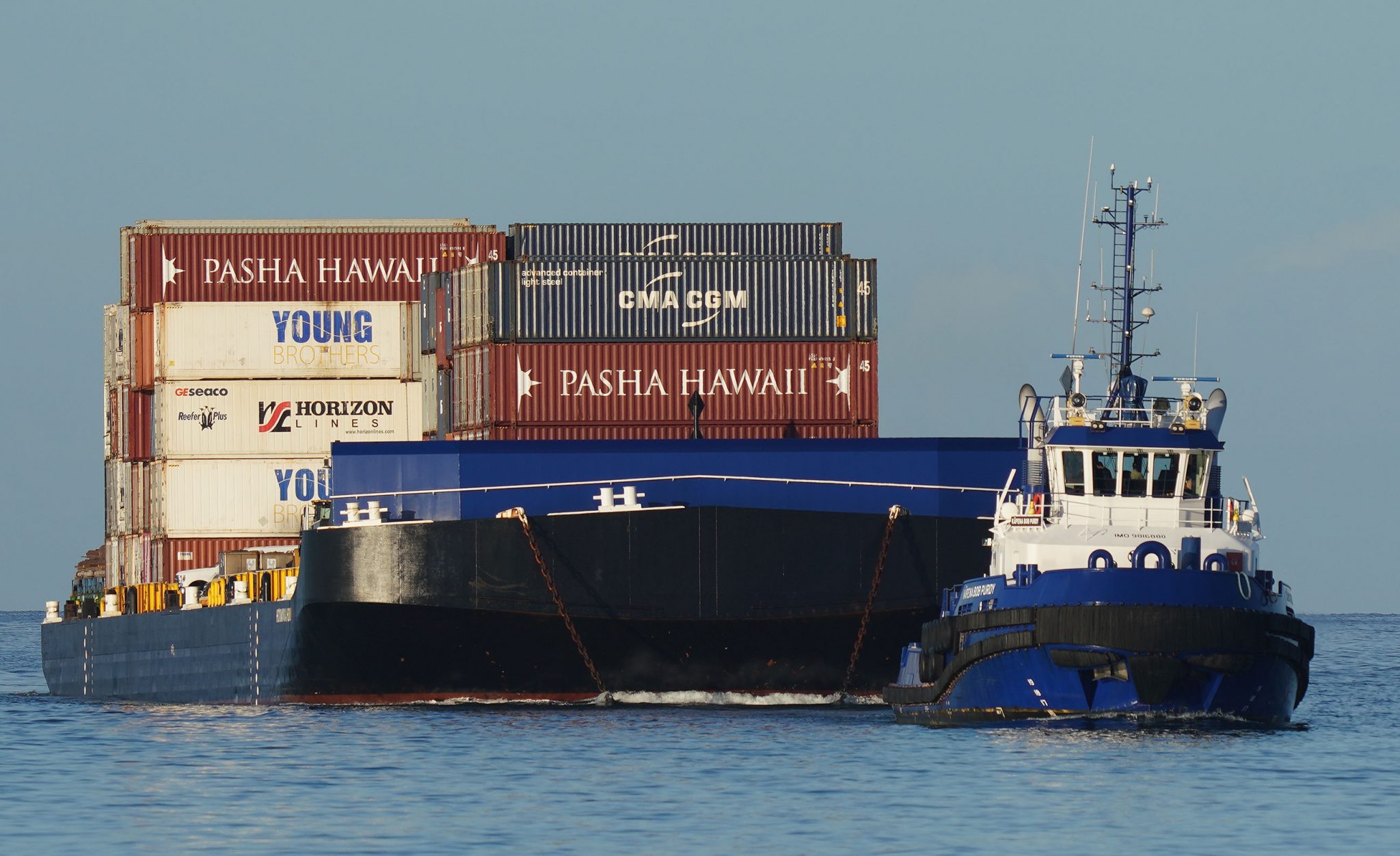 Young Brothers container barge enters Honolulu Harbor.