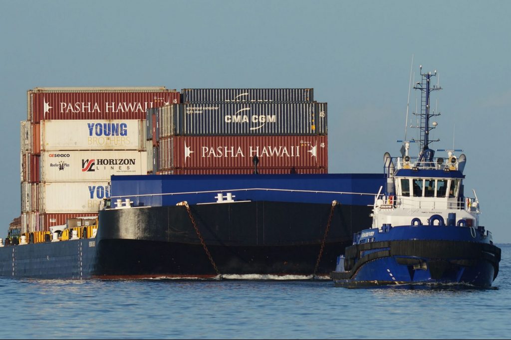 Young Brothers container barge enters Honolulu Harbor.
