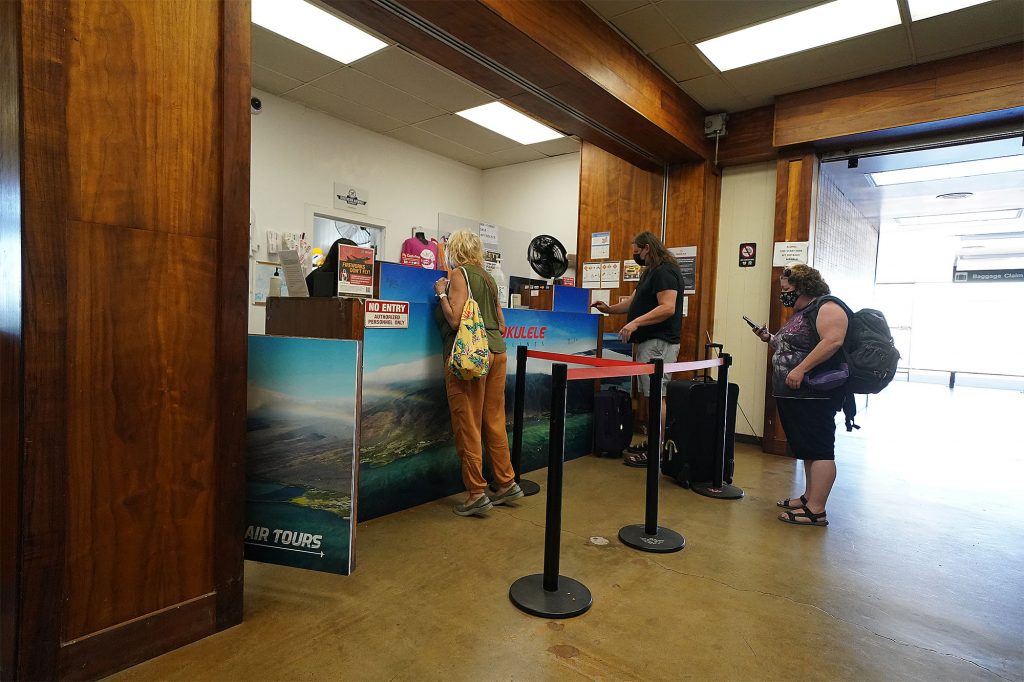 Passengers line up at Mokulele Airlines located at the Molokai Airport.