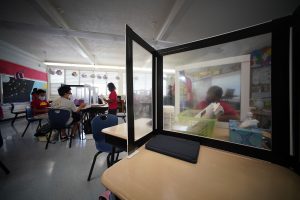 Students work with plastic barriers in Pauoa Elementary School 5th grade Teacher Jeanne Oliveira’s classroom during the Covid-19 pandemic. October 28, 2021