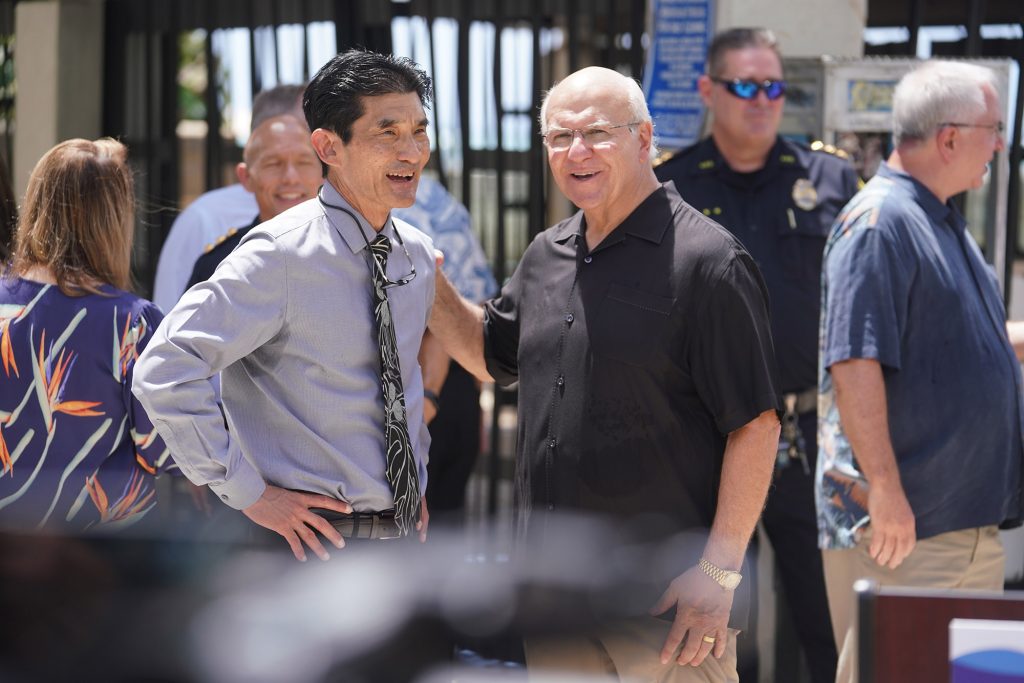 Paul Kosasa, president and CEO of ABC Stores, pledged $90,000 to hire an executive to coordinate the public safety efforts by Waikiki businesses speaks to Mayor Rick Blangiardi after press conference announcing Safe Sound Waikiki.