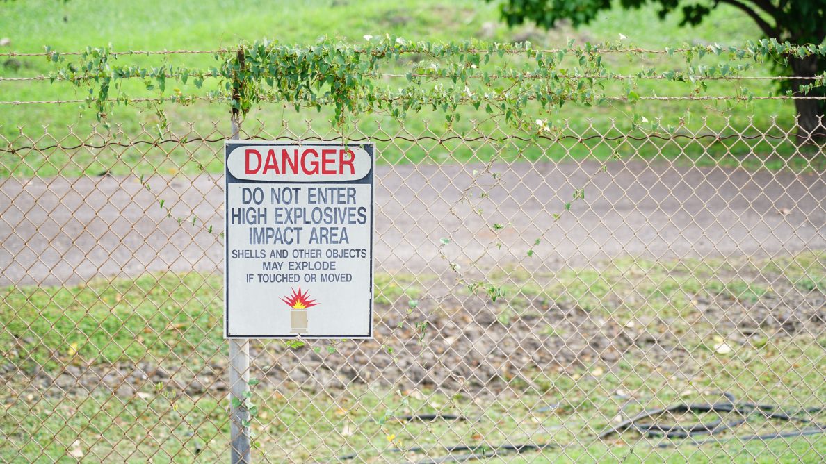 A "danger" sign alerting readers to the presense of unexploded ordnance
