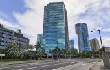 Hokua tower apartment complex dominates the center of the scene viewed from across Ala Moana Blvd.