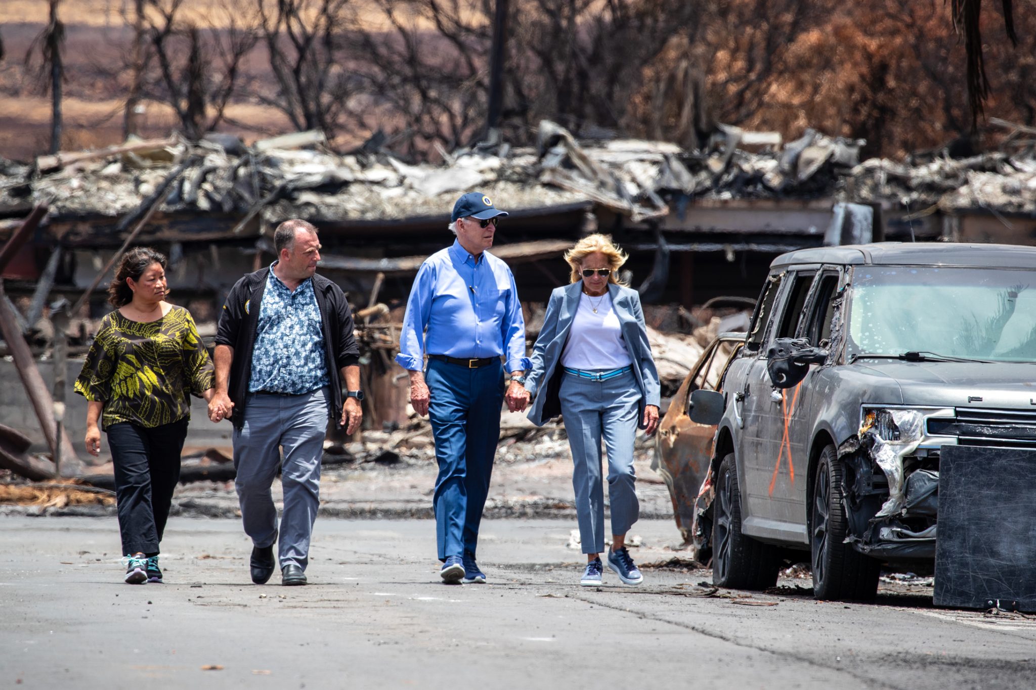 President Biden, First Lady Jill Biden, Gov. Josh Green and his wife, Jaime Green walk down Front Street in Lahaina, Monday. (Nathan Eagle/Civil Beat/2023)