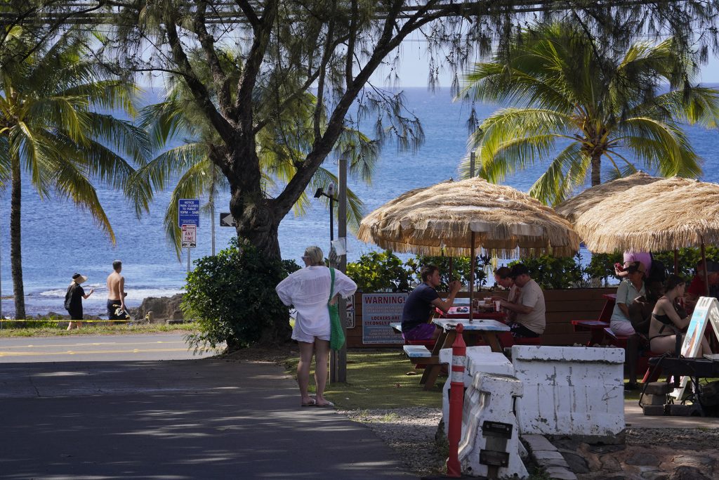 An area mauka of Sharks Cove with food trucks and water sports for tourist is photographed Wednesday, Nov. 8, 2023, in Haleiwa. The businesses here will struggle with proposed development taking over the area. (Kevin Fujii/Civil Beat/2023)