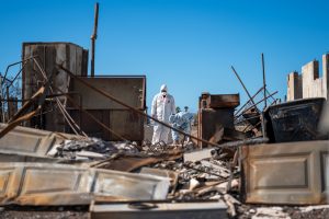 Mike and wife Andreza Cicchino look through the ashes of their home on Pupu Place in Lahaina. (Nathan Eagle/Civil Beat/2023)