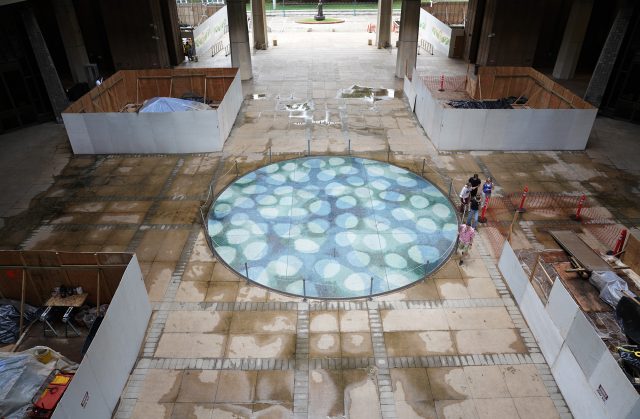 Construction barriers surround the reflecting pool in the center of the Capitol Wednesday, Dec. 20, 2023, in Honolulu. The basement of the building has been damaged by leaking water from the centerpiece. (Kevin Fujii/Civil Beat/2023)