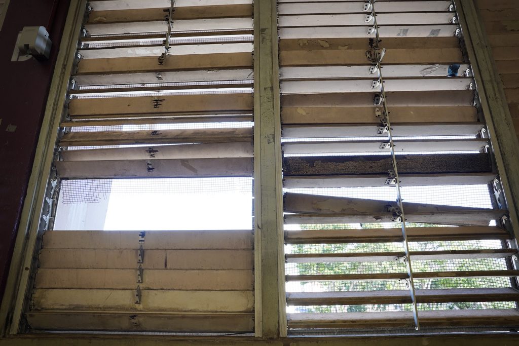 Broken windows of Farrington High School’s Kitamura Gym are photographed Friday, Dec. 29, 2023, in Honolulu. Lack of CIP funding for repairs and renovations have created a safety hazard for students, faculty, staff and visitors. (Kevin Fujii/Civil Beat/2023)