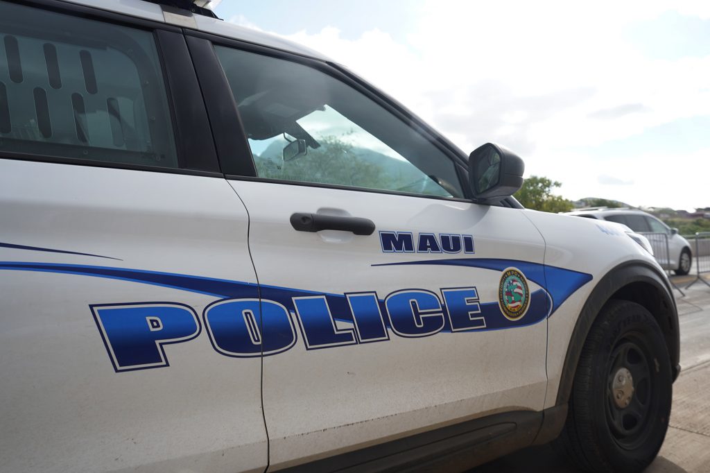 A Maui Police Department vehicle is photographed during the Hoʻūlu Lahaina Unity Walk Saturday, Jan. 20, 2024, in Lahaina. (Kevin Fujii/Civil Beat/2024)