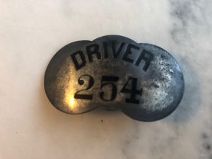 A metal plaque with the words "Driver 254"
