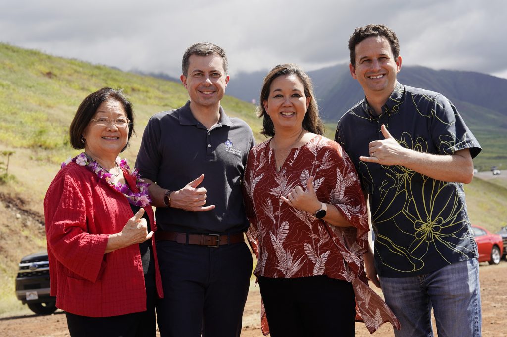 Senator Mazie Hirono, from left, Transportation Secretary Pete Buttigieg, Rep. Jill Tokuda and Sen. Brian Schatz pose for a photo Wednesday, Feb. 21, 2024, in Lahaina. (Kevin Fujii/Civil Beat/2024)