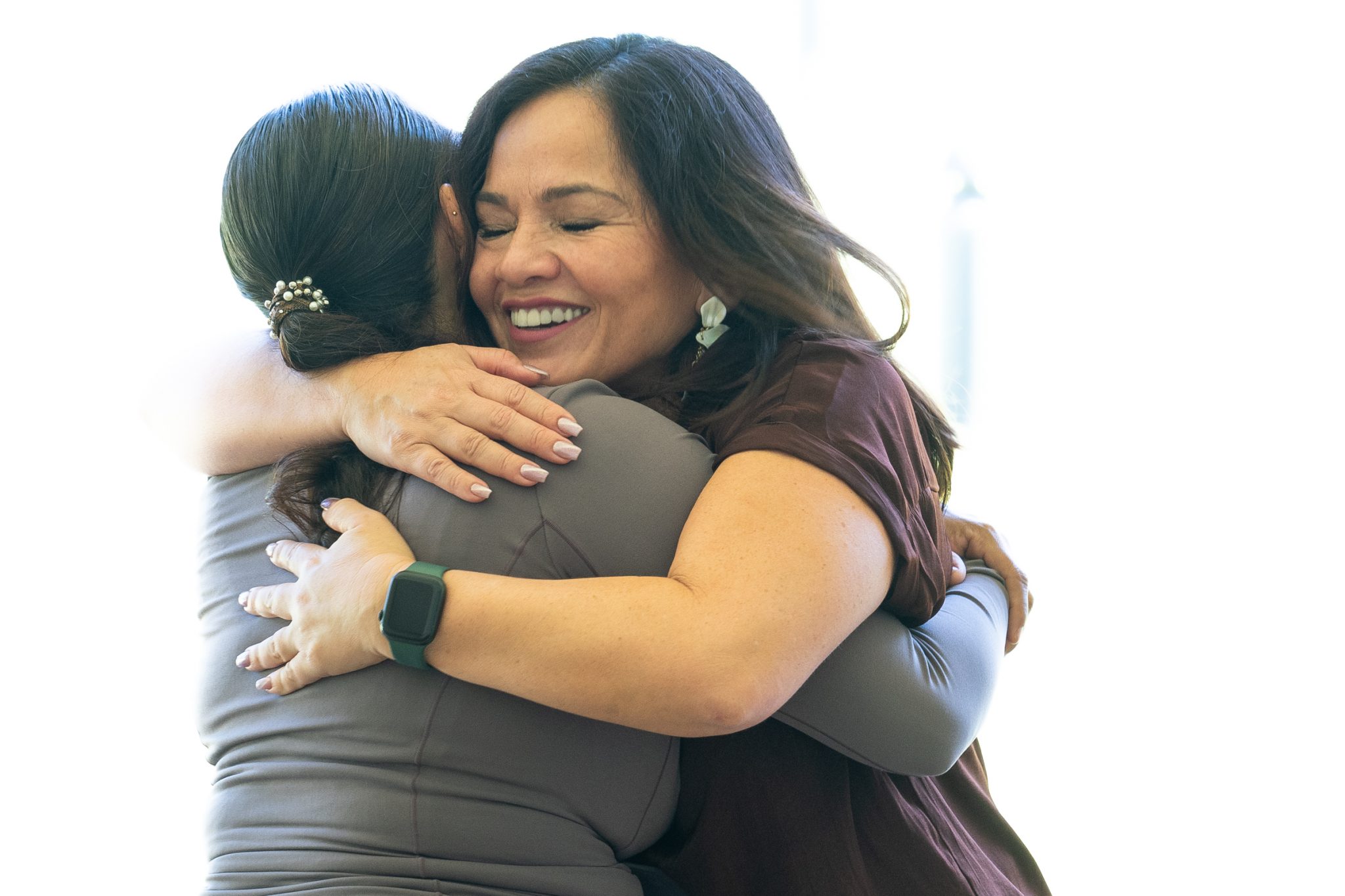 FEMA Interpreter Carolina Davis (brown top) greets Spanish speaking immigrant Victoria Silva at Lahaina Civic Center, Friday March 1st, 2024. The two became acquainted when Victoria  sought assistance through FEMA following the devastating fires of August 8th. (David Croxford/Civil Beat/2024)