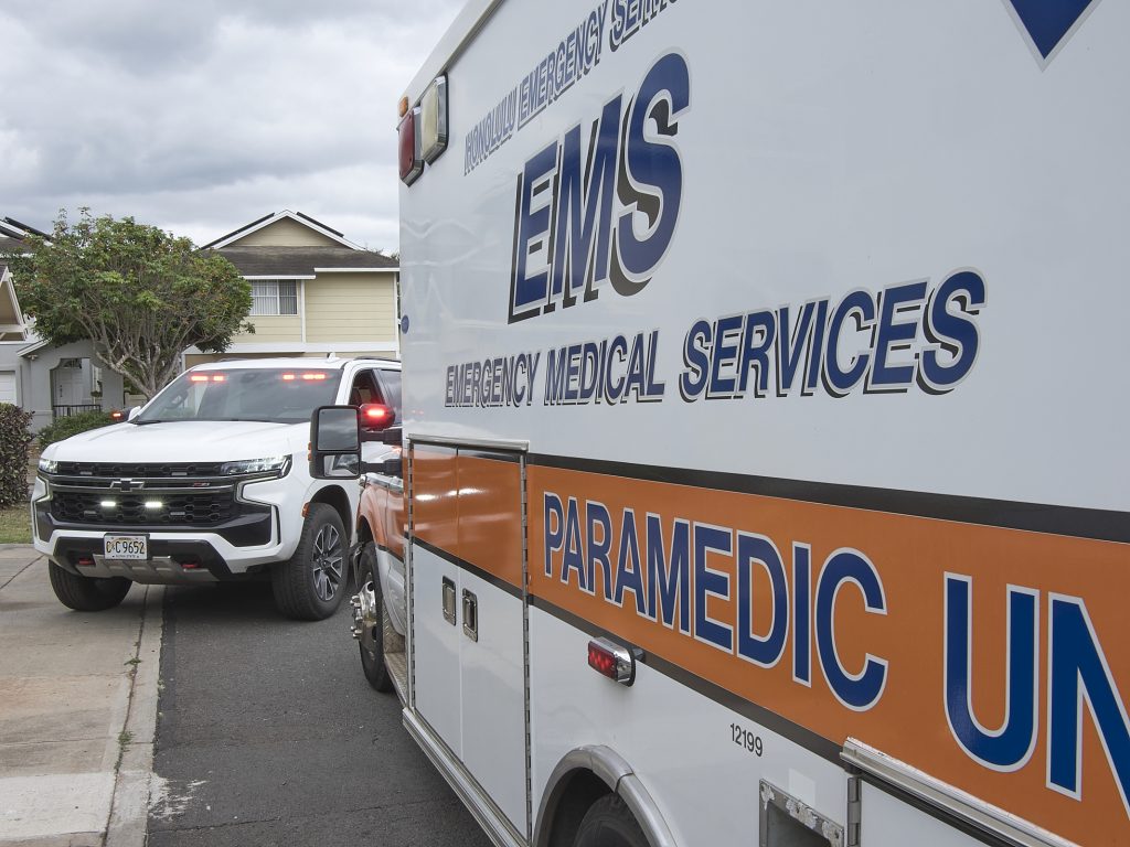 City & County EMS Director Dr. Jim Ireland fields questions from Civil Beat’s Ben Angarone during an EMS ridealong March 18th, 2024. An EMS from Honolulu City and County waits to take a fall patient to a local hospital.(David Croxford/Civil Beat/2024)