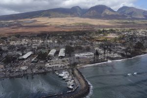 Malu Ulu O Lele Park sits in the upper right corner amid the destruction of Lahania town Thursday, Aug. 10, 2023, in Maui. The park sits on a former fishpond in the Mokuula area. A sheen of oil is also visible inside Lahaina Harbor. (Kevin Fujii/Civil Beat/2023)