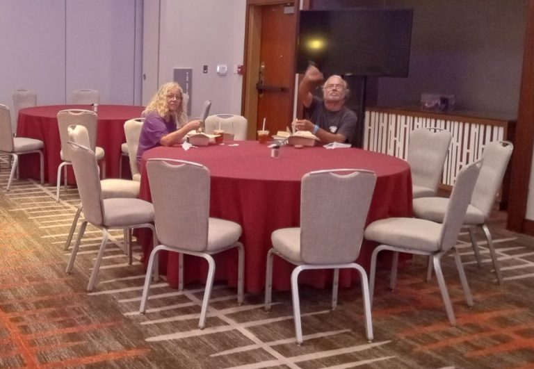 People displaced from the Maui wildfires eat dinner provided by the American Red Cross at the Hyatt Regency Maui Resort and Spa. (Thom Leonard)