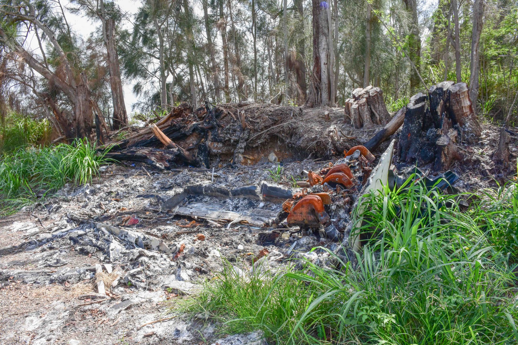 The charred remains of one of the 37 fires that have occurred along Holomua Road this year will be removed as part of a cleanup before wildfire season on Maui. (Cammy Clark/Civil Beat/2024)