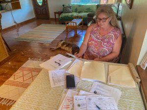 Bettina Robinson goes through documents, emails and receipts she accumulated during the process to have her home in Kihei part of the Federal Emergency Management Agency's direct-lease program. (Cammy Clark/Civil Beat/2024)