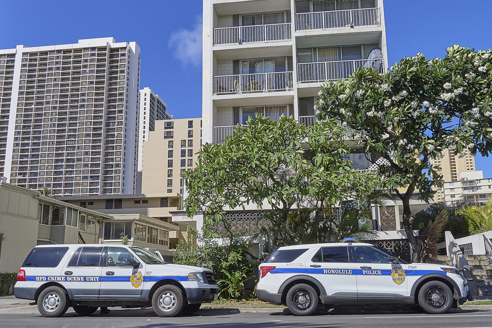 The scene of a fatal Police shooting at 2509 Ala Wai Blvd. photographed at 9:40 am.  The barricaded victim came out of the apartment brandishing a gun and pointed toward officers after non lethal canisters containing CS gas were deployed. The officers returned fire and fatally wounded the suspect who was believed to be the culprit in three earlier robberies.(David Croxford/CivilBeat/2024)