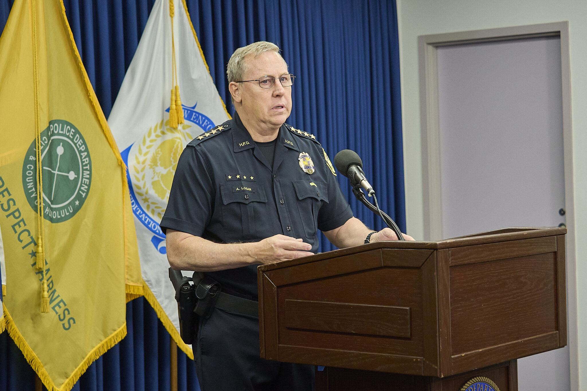 HPD Chief Joe Logan reports information of the fatal Police shooting at 2509 Ala Wai Blvd. The barricaded victim came out of the apartment brandishing a gun and pointed toward officers after non lethal canisters containing CS gas were deployed. The officers returned fire and fatally wounded the suspect who was believed to be the culprit in three earlier robberies.(David Croxford/CivilBeat/2024)