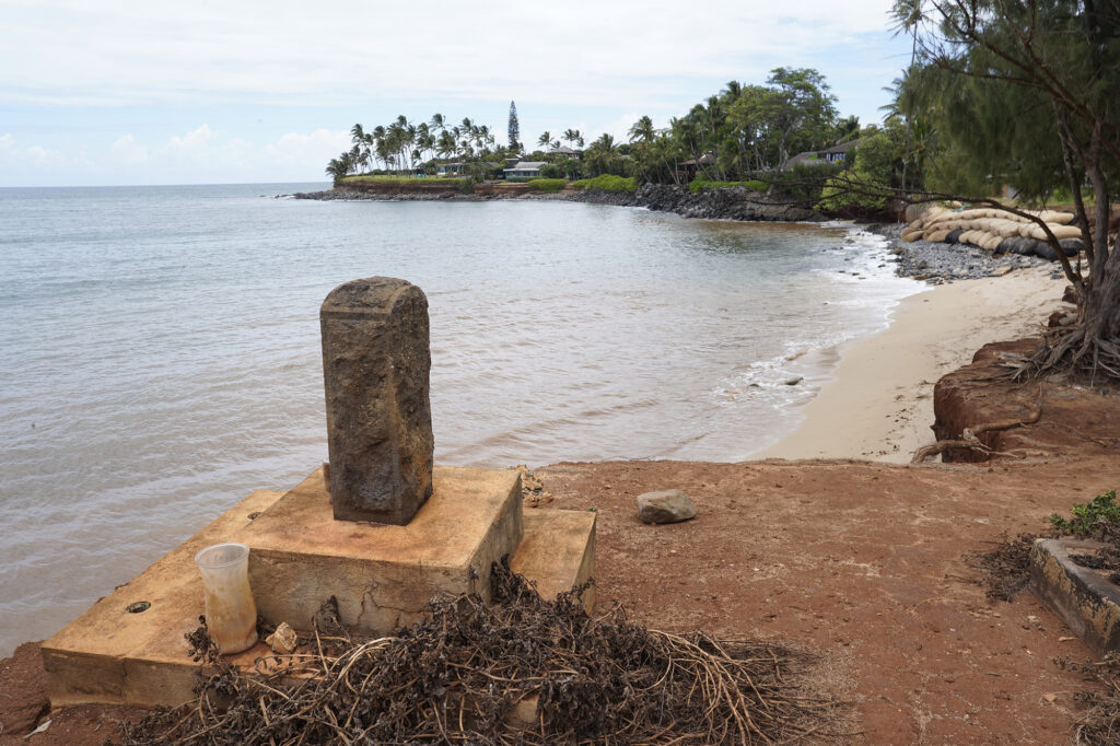 A grave marker sits on the new edge of the Paia Mantokuji Soto Mission cemetery Saturday, July 20, 2024, in Paia. The Soto Zen Buddhist temple was founded in 1906 on Maui’s North Shore. Land upon which the mission sits is eroding into the Pacific Ocean. (Kevin Fujii/Civil Beat/2024)