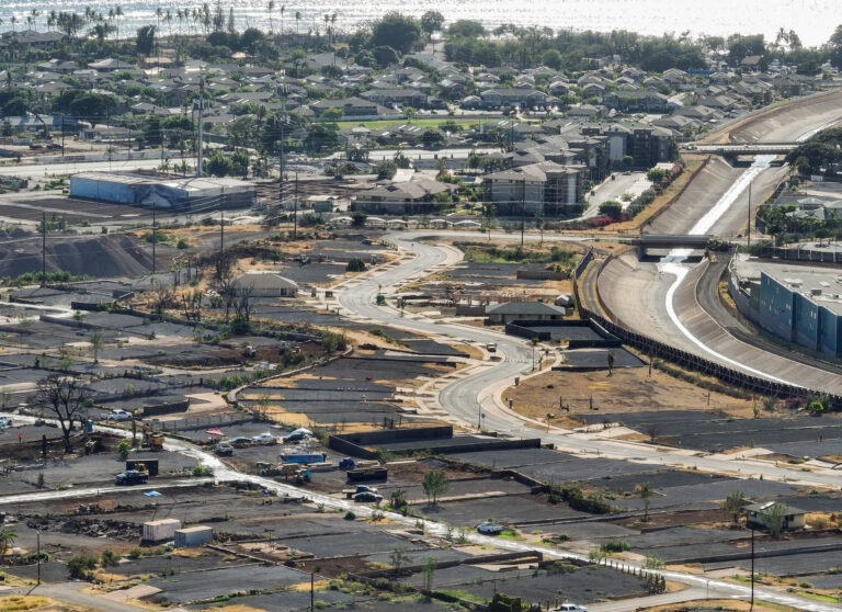 Komo Mai Street wends through Lahaina near the Kahoma Stream channel where hundreds of residential properties have been cleared since the Aug. 8, 2023, fires. This photo was taken in July. (Nathan Eagle/Civil Beat/2024)