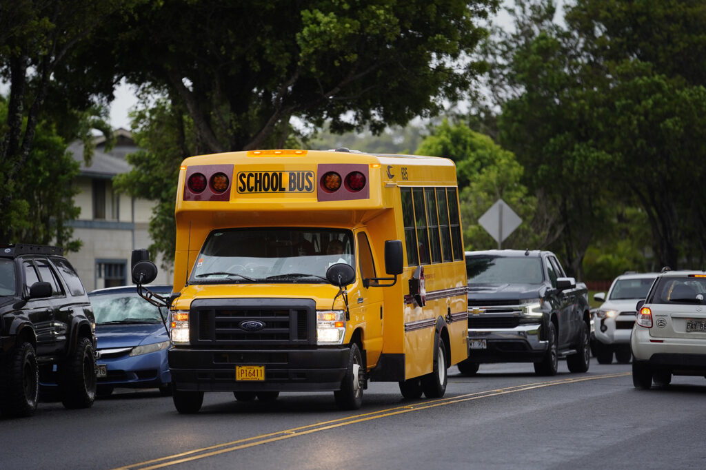 School buses are photographed Monday, Aug. 26, 2024, in Mililani. The Department of Education was criticized for announcing the cancellation of numerous bus routes three days before the 2024 autumn school semester began. (Kevin Fujii/Civil Beat/2024)