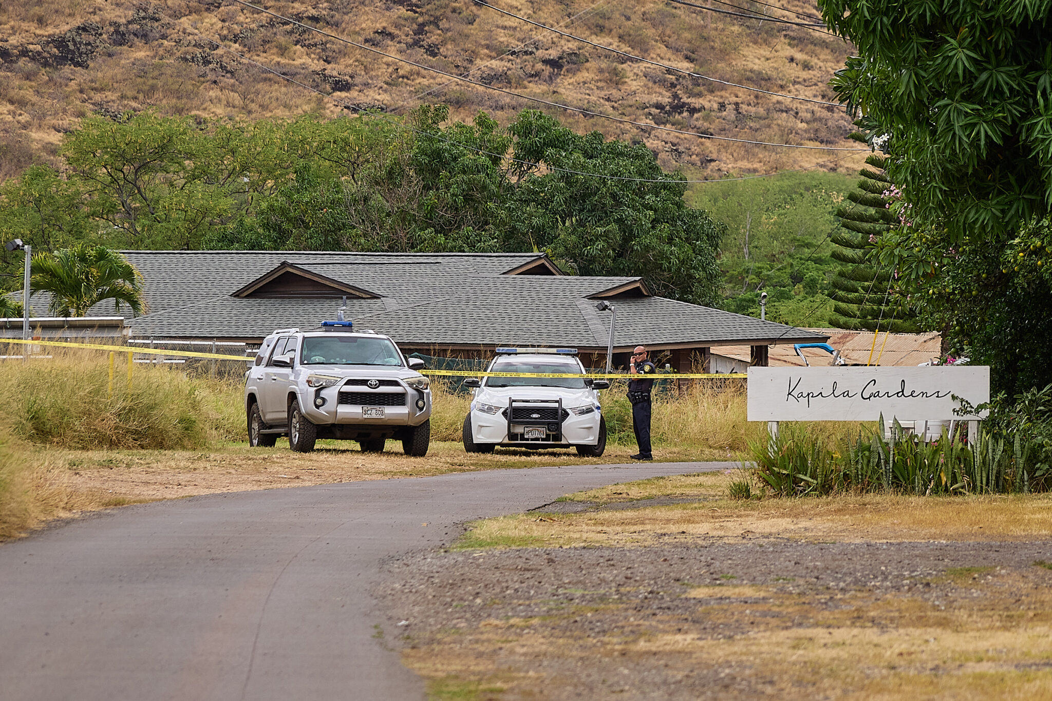 Honolulu Police Dept maintained a presence in the 85-1300 block of Waianae Valley Road on Sunday afternoon while investigations proceeded into the fatal shooting of three individuals at a graduation party around 11.30pm on Saturday evening August 31st, 2024. (David Croxford/Civil Beat/2024
