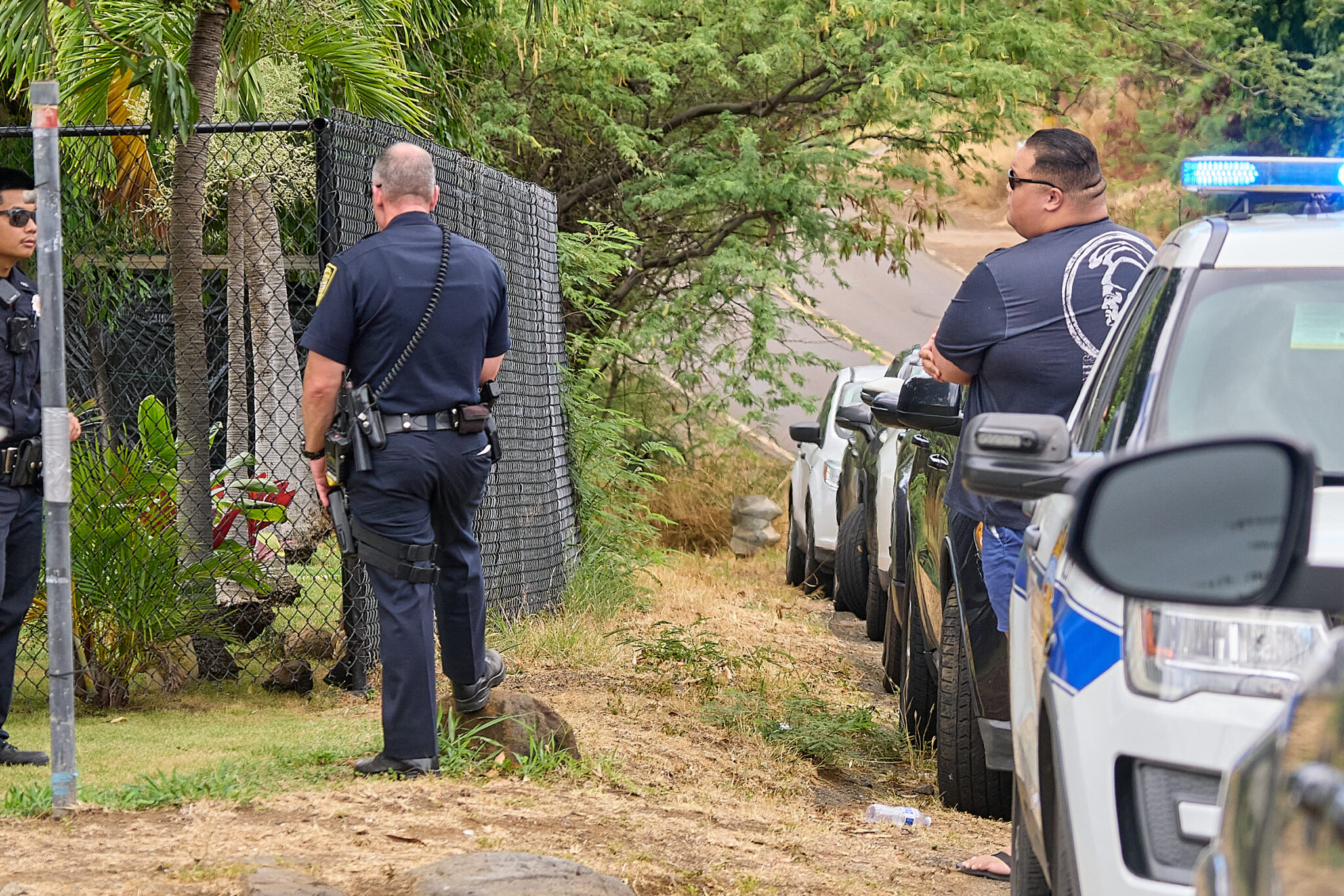 Honolulu Police Dept maintained a presence in the 85-1300 block of Waianae Valley Road on Sunday afternoon while investigations proceeded into the fatal shooting of three individuals at a graduation party around 11.30pm on Saturday evening August 31st, 2024. (David Croxford/Civil Beat/2024
