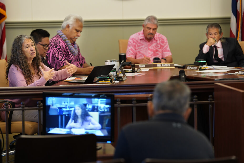Kauai County Council member Felicia Cowden, left, speaks to the organizers of the 11th Annual Harvest Festival while Addison Bulosan, Vice Chair KipuKai Kuali’i, Chair Mel Rapozo and Bill DeCosta look on during their meeting Wednesday, Oct. 9, 2024, in Lihue. (Kevin Fujii/Civil Beat/2024)