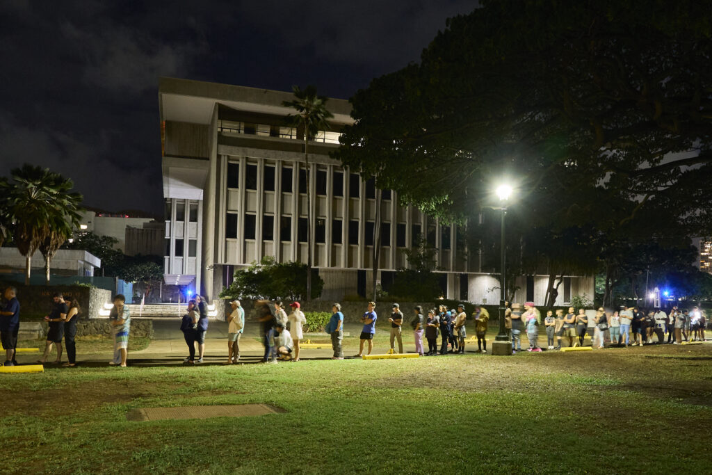 After a full twelve hours of voting the line to cast a vote at one of only two locations on Oahu that remained open, stretched around Honolulu Hale and out toward the Fasi building. (David Croxford/Civil Beat/2024)