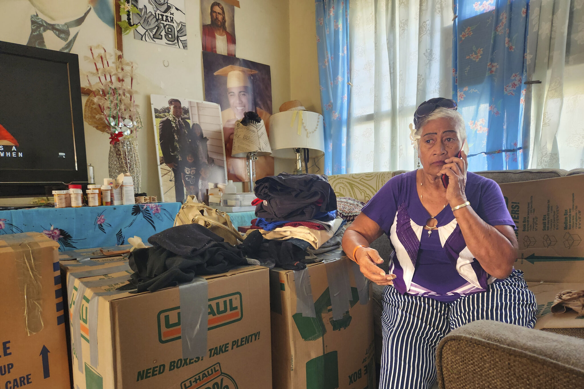 Lutita Momosea, a resident of Kuhio Homes sits among packed boxes. She is one of several that are being forced to leave their homes so that renovations and reconstruction can occur.(Jeremy Hay/Civil Beat/2025)
