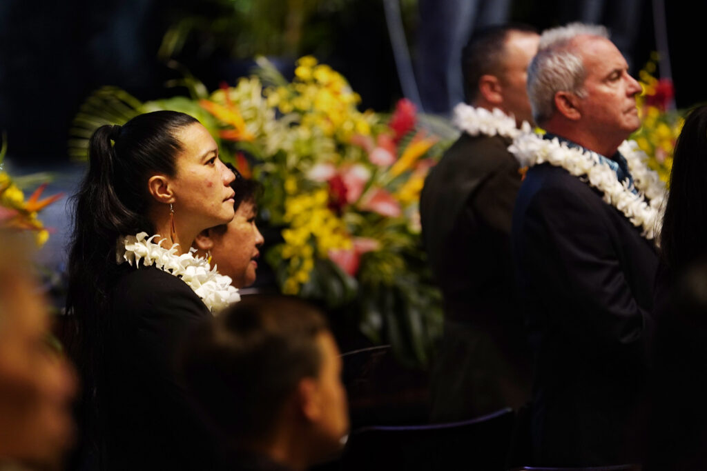 Maui County Council member Keani Rawlins-Fernandez stands for Royal Orders entering the auditorium before Mayor Richard Bissen’s state of the county address Friday, March 7, 2025, in Kahului. (Kevin Fujii/Civil Beat/2025)